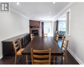 A dining room with a wooden table and chairs.
