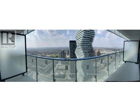 A glass balcony overlooks a cityscape.