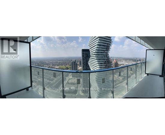 A glass balcony overlooks a cityscape.