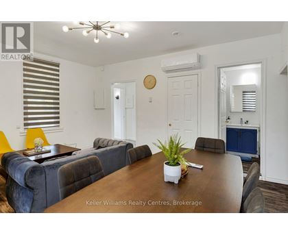 A room with a ceiling fan and a window with blinds.