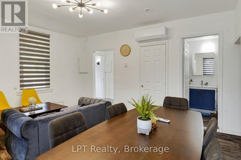 A room with a ceiling fan and a window with blinds.