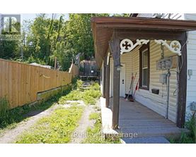 A wooden fence and a porch with a cross design on it.