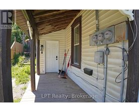 A white door is on the left side of a house.