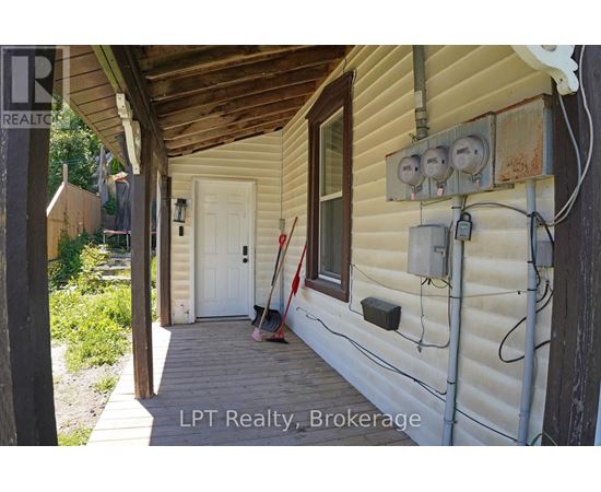 A white door is on the left side of a house.