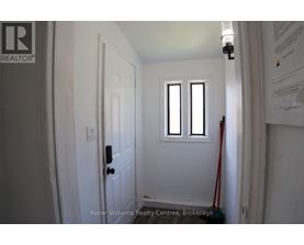 A white door with a black handle and a window above it.