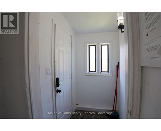 A white door with a black handle and a window above it.