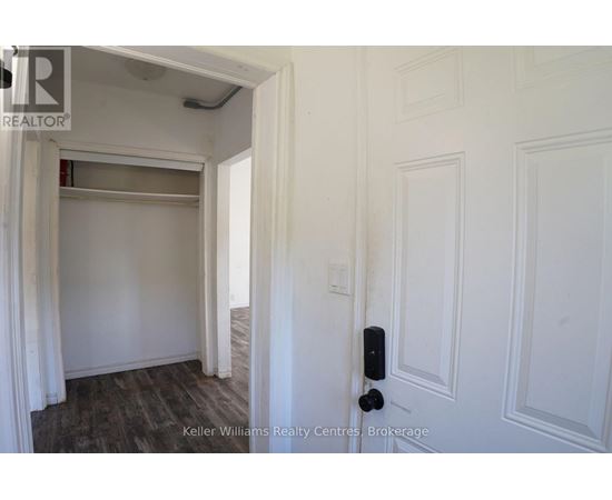 A white door with a black handle is in a room with white walls.
