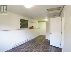 A room with a white door and a window with blinds.