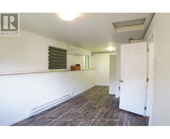 A room with a white door and a window with blinds.