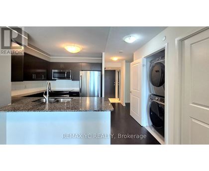 A kitchen with a refrigerator, microwave, and dishwasher.