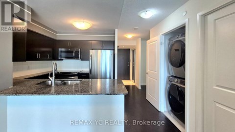A kitchen with a refrigerator, microwave, and dishwasher.