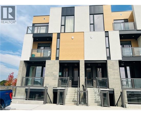 A modern multi-story building with balconies and doors numbered from 10 to 14.