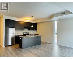 A modern kitchen with a refrigerator, stove, and island.