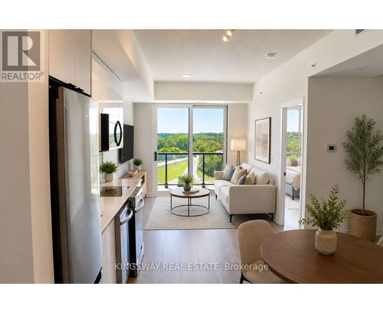 A well-lit, modern kitchen with a dining table and chairs in the foreground and a balcony with a view of trees in the background.