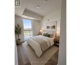A bedroom with a large bed and a view of the outside.