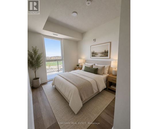 A bedroom with a large bed and a view of the outside.