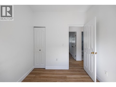 A white door is on the left and a white door with a gold handle is on the right.