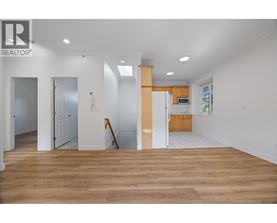 A realtor logo is on the wall of a white room.