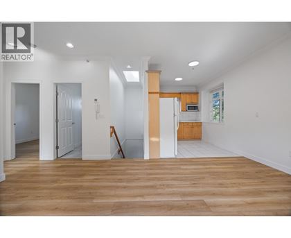 A realtor logo is on the wall of a white room.