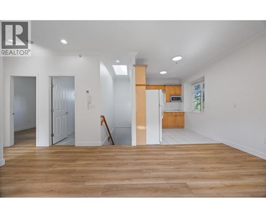 A realtor logo is on the wall of a white room.