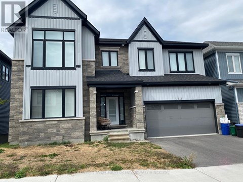 A modern two-story house with a garage is for sale.