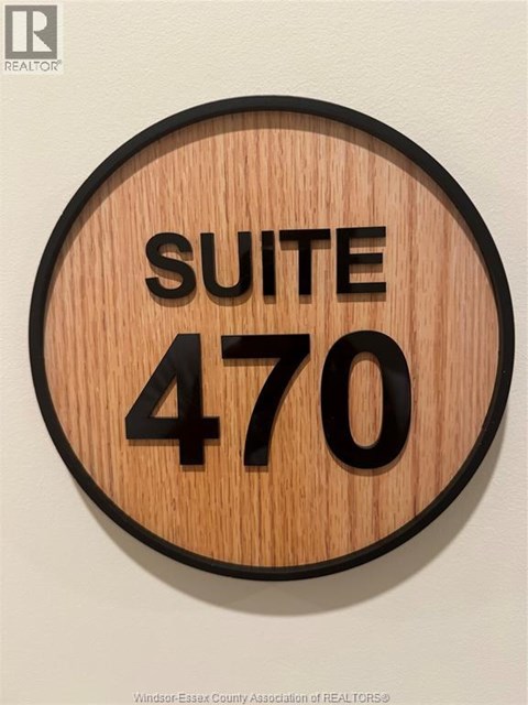 A wooden sign with the words "SUITE 470" on it.