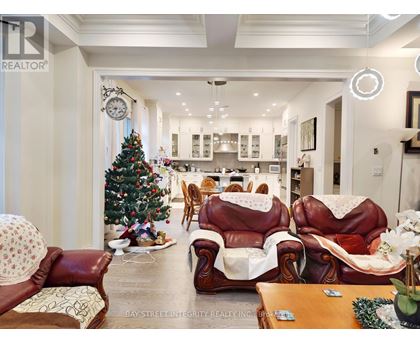 A living room with a Christmas tree and leather chairs.