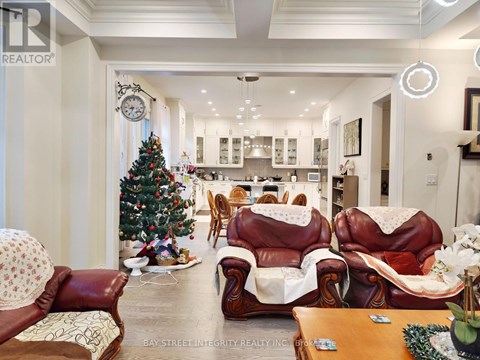 A living room with a Christmas tree and leather chairs.