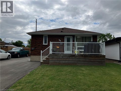 A house with a white fence and a car parked in front.