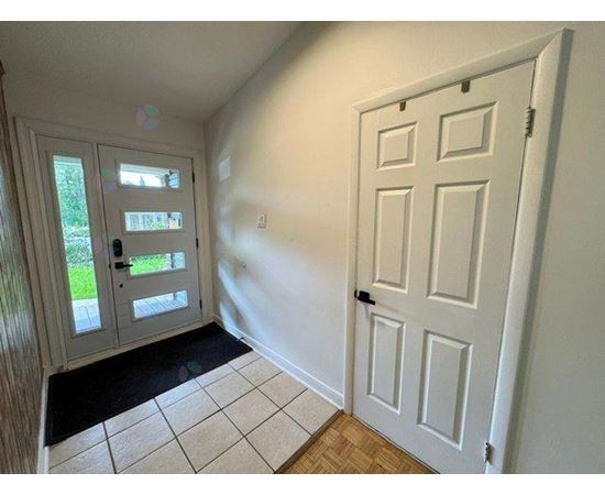 A white door is on the right and a glass door is on the left.
