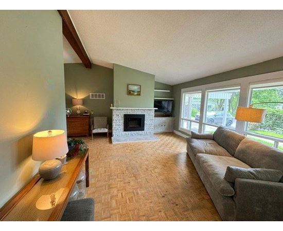A living room with a fireplace and a couch.