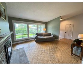 A living room with a couch, a table, and a fireplace.