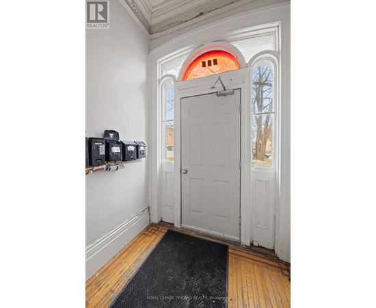 A white door with a black mat in front of it.