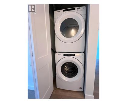 Two front loading washing machines in a small laundry room.