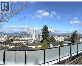 A view of a residential area with apartment buildings and houses with a clear blue sky in the background.