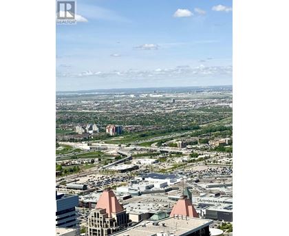 A cityscape with a clear sky and scattered clouds.