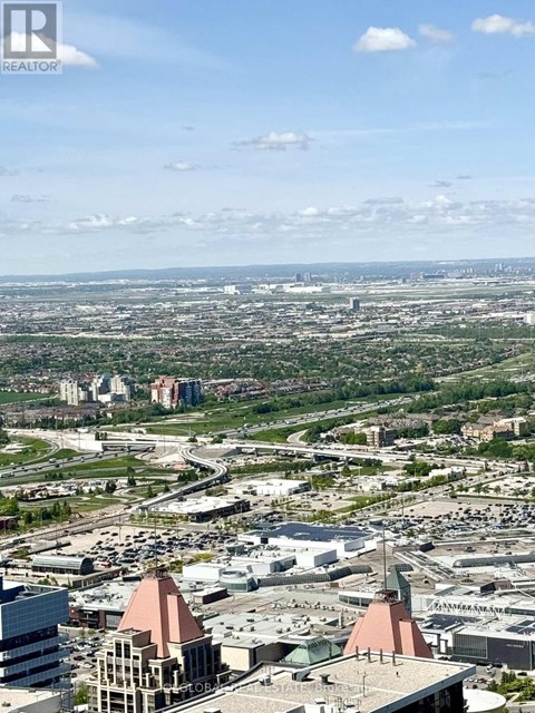 A cityscape with a clear sky and scattered clouds.