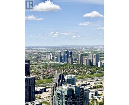A cityscape with tall buildings and a clear sky.