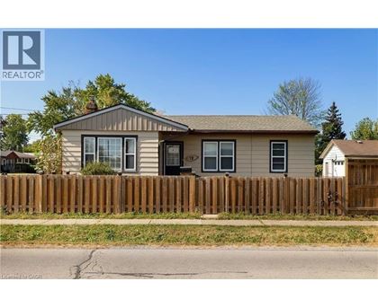 A house with a brown fence in front of it.