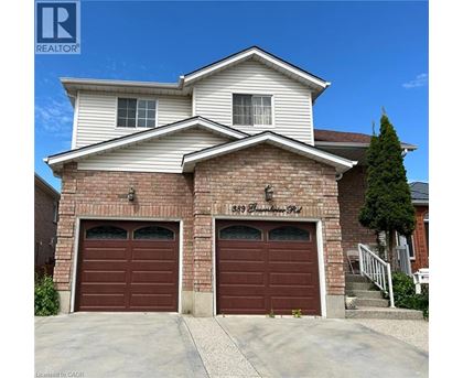 A two-story house with a garage on the first floor.