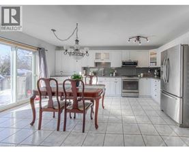 A well-lit kitchen with a dining table and chairs.