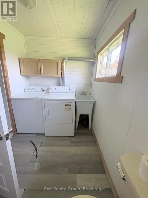 A small kitchen with a stove top oven and a sink.