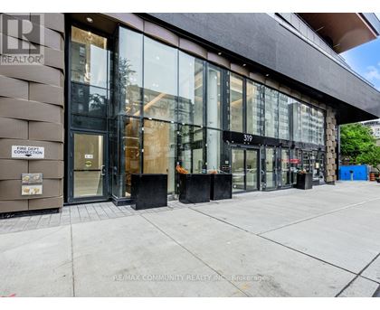 The image shows the front of a building with the sign "RE/MAX COMMUNITY REALTY INC." on the left side.