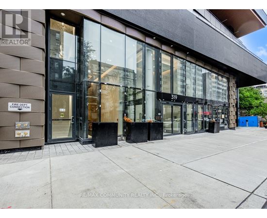 The image shows the front of a building with the sign "RE/MAX COMMUNITY REALTY INC." on the left side.