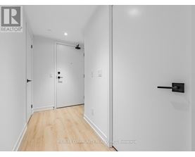 A hallway with a door on the left and a door on the right.