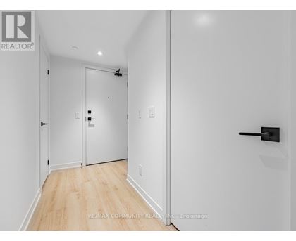 A hallway with a door on the left and a door on the right.