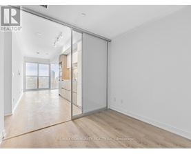 A room with a sliding glass door leading to a balcony.
