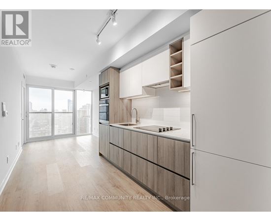 A modern kitchen with wooden cabinets and a large island.
