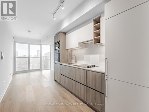A modern kitchen with wooden cabinets and a large island.
