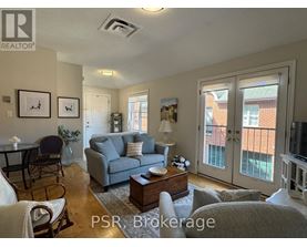 A living room with a couch, chairs, and a coffee table.